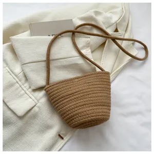 Detailed view of stylish brown woven rope bucket bag with clean texture and chic shoulder strap.