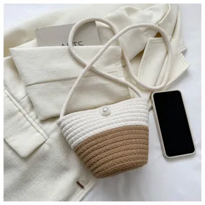 Chic two-tone woven bucket bag with pearl button, stylish shoulder crossbody bag for daily.
