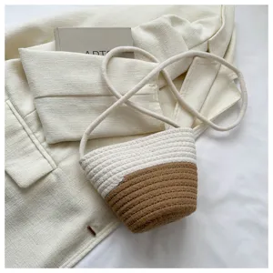 Woven bucket bag detail showcasing color-blocked beige and brown textile craftsmanship.