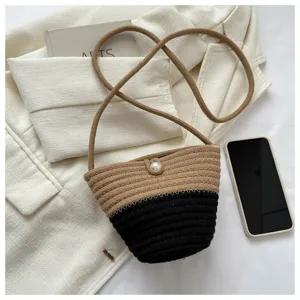 Stylish two-tone woven crossbody bucket bag with pearl decoration for women casual daily use.