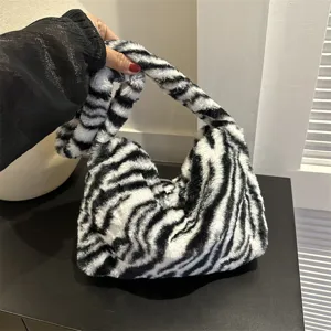 Zebra print plush shoulder bag for women, trendy fluffy underarm handbag, stylish fuzzy purse.