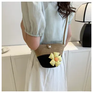 Chic colorblock woven crossbody bag featuring a cute fabric flower and pearl button detail.