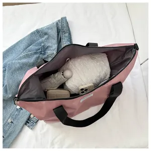 Pink canvas tote bag interior view, large capacity shoulder bag detail showing items inside.