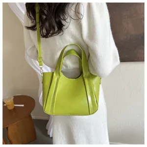 Green leather bucket bag for women, stylish soft PU leather shoulder crossbody bag detail.