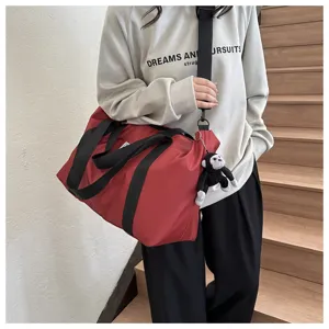Large capacity red nylon shoulder bag travel tote bag casual handbag for women details view.