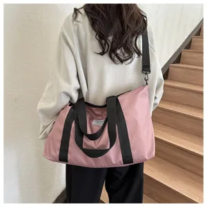 Casual large capacity pink tote bag with black handles and shoulder strap for travel.