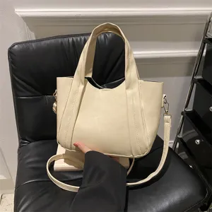 Casual soft leather tote bag for women, versatile beige shoulder and crossbody bucket handbag.