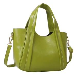 Green faux leather bucket bag, stylish casual handbag with top handle and crossbody strap.