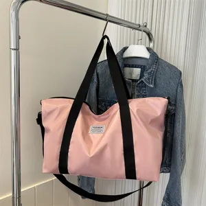 Large capacity pink travel duffel bag for women, casual shoulder tote with double handles.