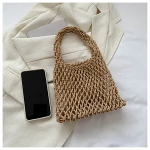 Detailed shot of a beige woven fishnet handbag showcasing texture and daily casual style.