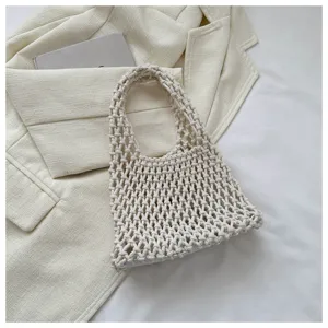 Detailed view of casual off-white woven mesh tote bag, featuring a minimalist aesthetic design.