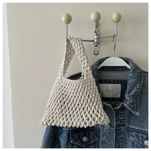 Detailed view of cream white woven net handbag, minimalist Korean style casual tote bag.