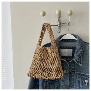 Detailed close-up showing the intricate woven texture and craftsmanship of the stylish straw net handbag.