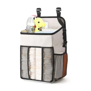 Hanging baby diaper organizer for crib and playpen with mesh pockets for newborn essentials.