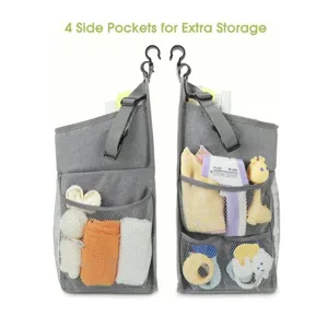 Grey hanging diaper organizer with mesh pockets for crib, convenient baby storage bag.