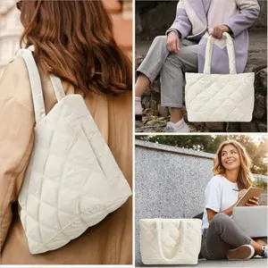 White quilted tote bag detail shot showing soft puffy fabric and comfortable shoulder straps.