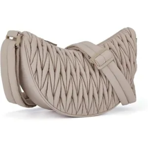 Close-up detail of the quilted puffer crescent shoulder bag showing pleated texture and strap.