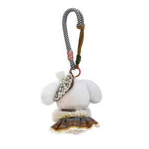Plush puppy keychain detail showing cute plaid skirt, lace hat and patterned strap.