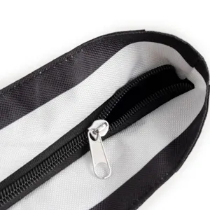 Detail view of the bag zipper opening, featuring clean stitching and durable metal puller.
