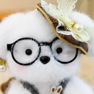 Cute white plush dog toy detail showing fluffy fur, black round glasses and plaid hat decor.