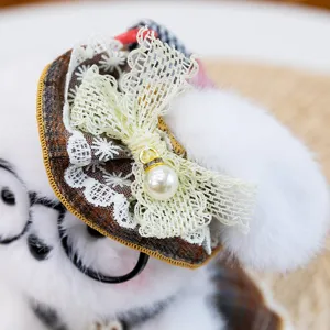 Cute plush toy detail shot featuring a mini lace bow hat and pearl pendant accessory.