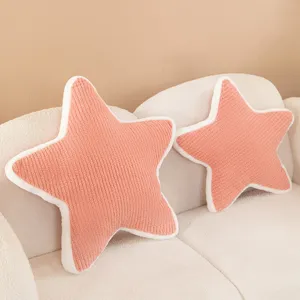 Nordic style plush star pillow detail, soft pink textured cushion on cozy white sofa.