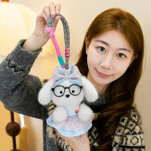 Cute white plush puppy doll keychain with black glasses, blue bow and colorful hanging rope.