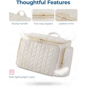 Quilted travel cosmetic bag featuring sturdy handle, two-way zippers and leather trims.