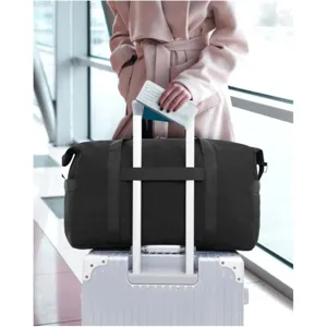 Large capacity black travel duffel bag with trolley sleeve and sturdy handles for fitness and trips.