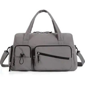 Gray travel duffel bag detail showcasing multi-pocket design, durable strap and secure zippers.