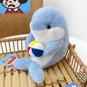 Cute blue dolphin plush toy holding a colorful ball, soft stuffed ocean animal doll for kids.