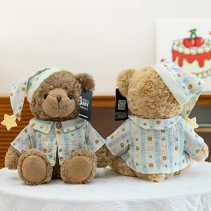 Couple teddy bear plush toys wearing cute pajamas and sleeping caps, soft and comforting.