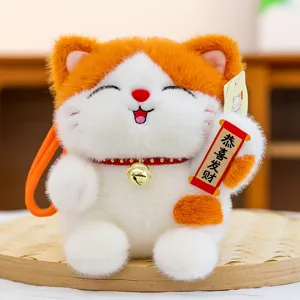 Cute lucky cat plush toy keychain, orange and white stuffed doll with bell and scroll.