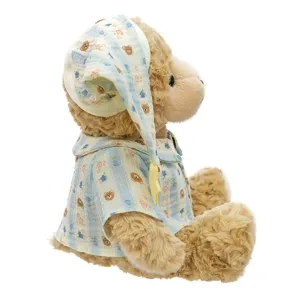 Cute brown plush bear toy wearing blue striped pajamas and nightcap, soft stuffed animal doll.