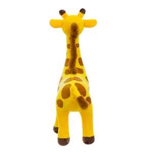 Detailed rear view of a cute yellow giraffe plush toy highlighting soft fabric and brown spots.