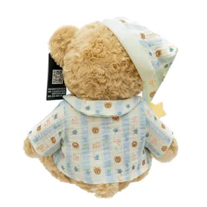 Plush teddy bear toy in blue striped pajamas and sleeping hat for soothing and hugging.