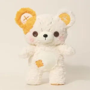 Detailed close-up of cute patchwork plush teddy bear toy with button eyes and soft stuffed body.