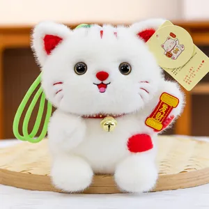 Cute lucky cat plush doll detail, white furry pendant with bell and red accents.