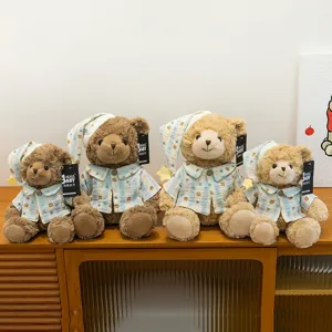Detailed shot of cute plush teddy bears in pajamas and nightcaps, soft stuffed toy set.