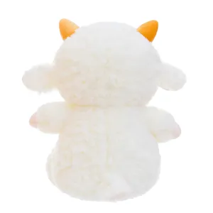Back view detail of cute white sheep plush toy with orange horns and soft fluffy fabric.