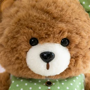 Cute brown plush teddy bear stuffed doll with green polka dot dress, soft and cuddly kids gift.