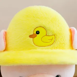 Cute plush toy detail shot showing yellow duck hat and soft pink pig doll for kids gift.