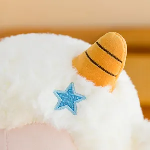 Cute plush toy detail shot featuring soft white faux fur, orange striped horn, and blue star.