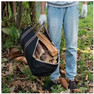 Detailed view of portable heavy-duty canvas firewood storage bag carrying logs for outdoor camping.
