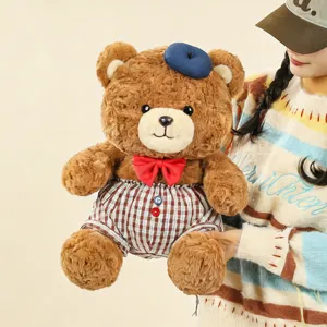 Cute plush teddy bear toy with blue beret red bow and plaid shorts soft doll detail view.