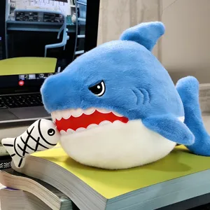 Cute blue shark plush toy detail shot showing the cute biting fish design on the study desk.