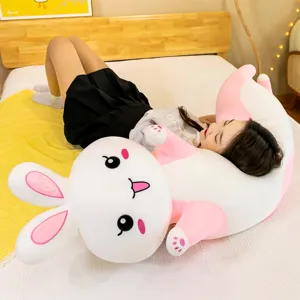 Detailed view of cute pink and white rabbit plush pillow, soft stuffed animal for comforting.
