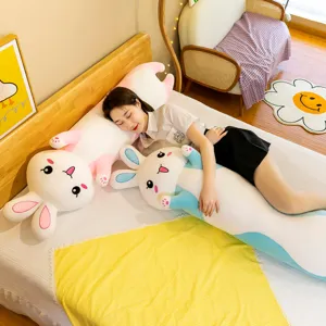 Detail view of the cute long rabbit plush pillow in a cozy bedroom setup for great comfort.