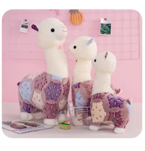 Cute plush alpaca toy detail view, soft stuffed llama doll featuring snowflake pattern.