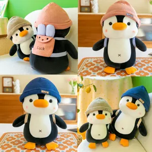 Cute penguin plush toy with knit hat and mini backpack, soft stuffed animal doll for kids gift.